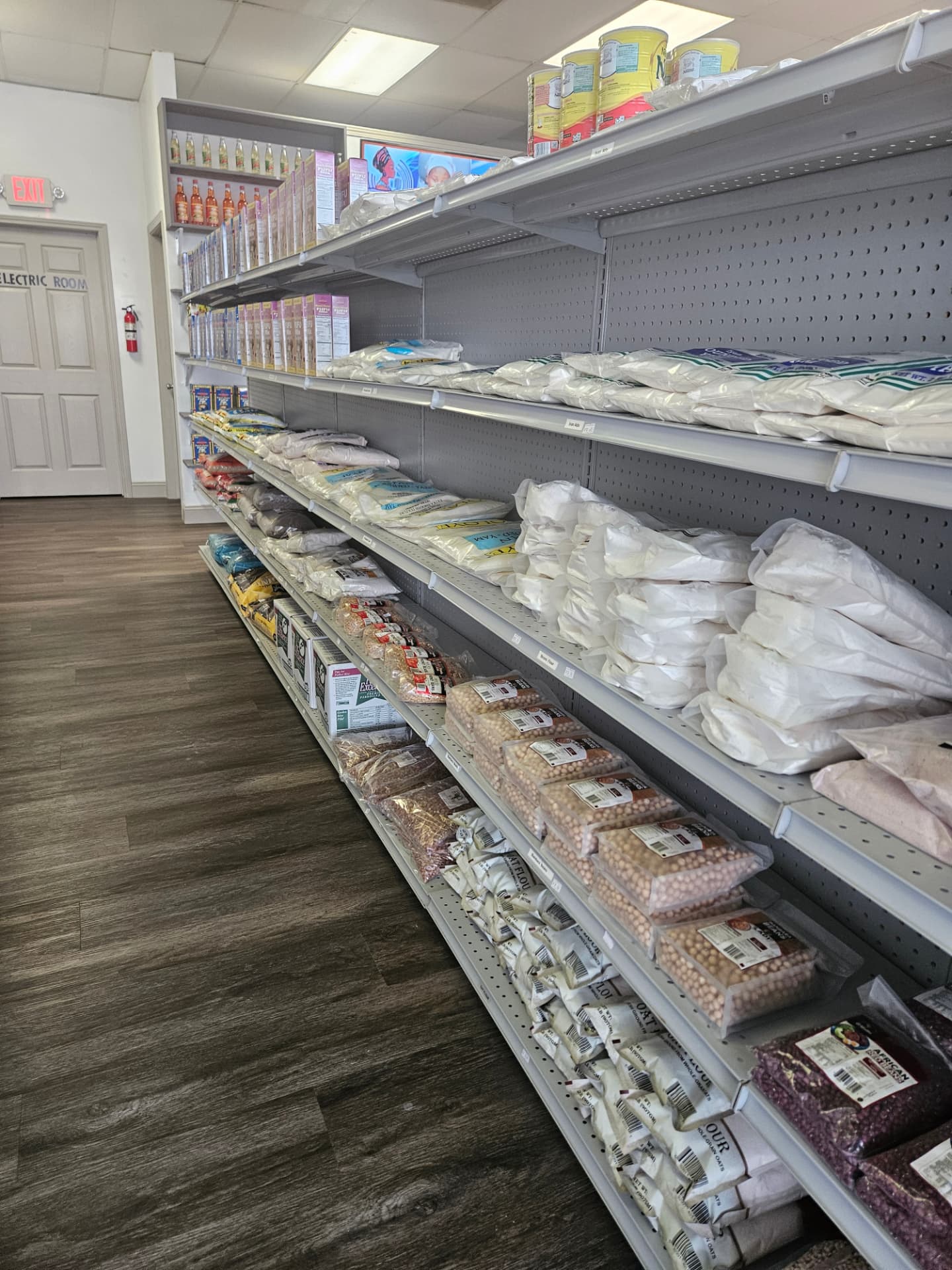 Pantry aisle stocked with flours, beans, yam and grains