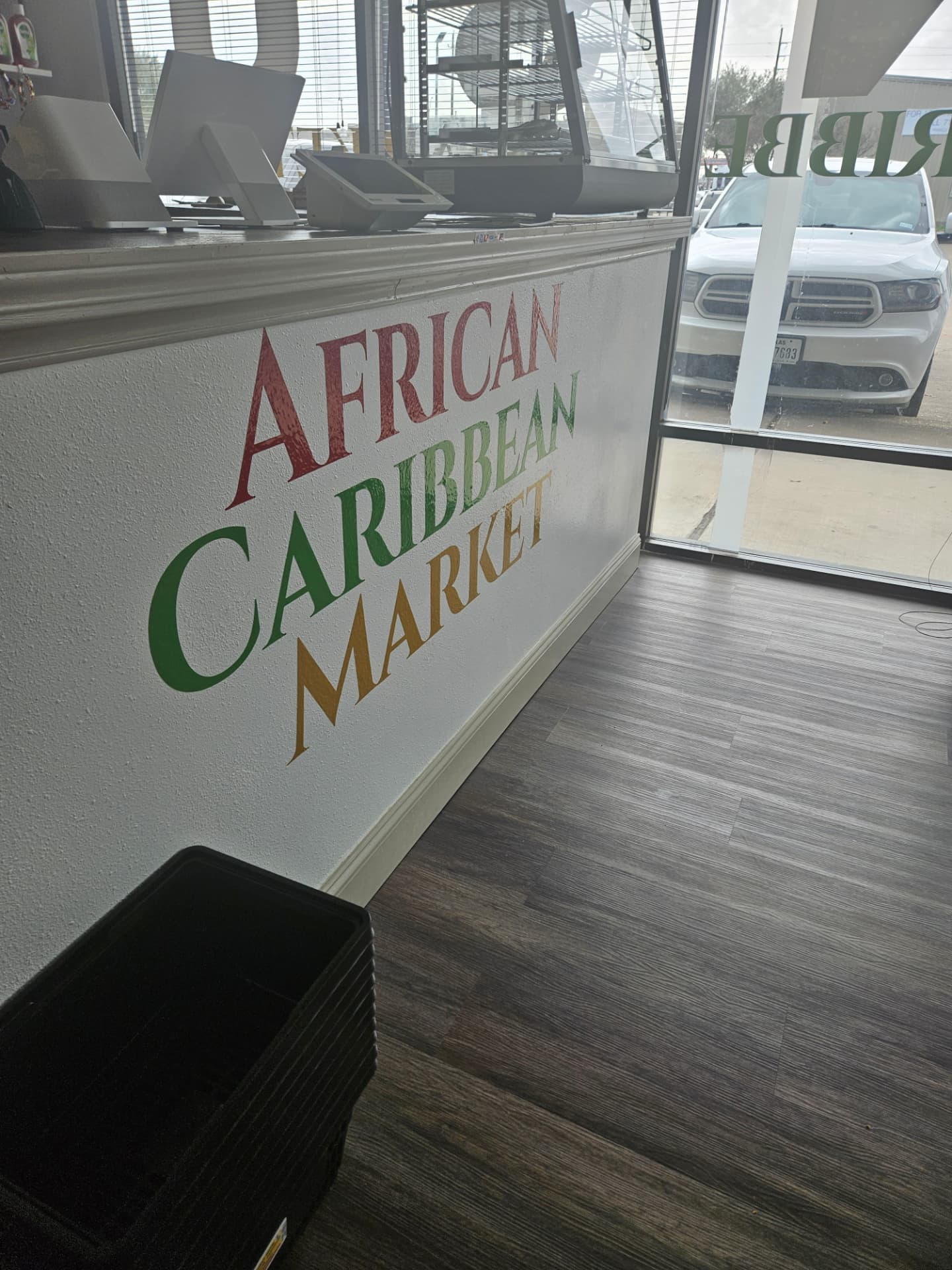 African Caribbean Market hand-painted sign by the front counter